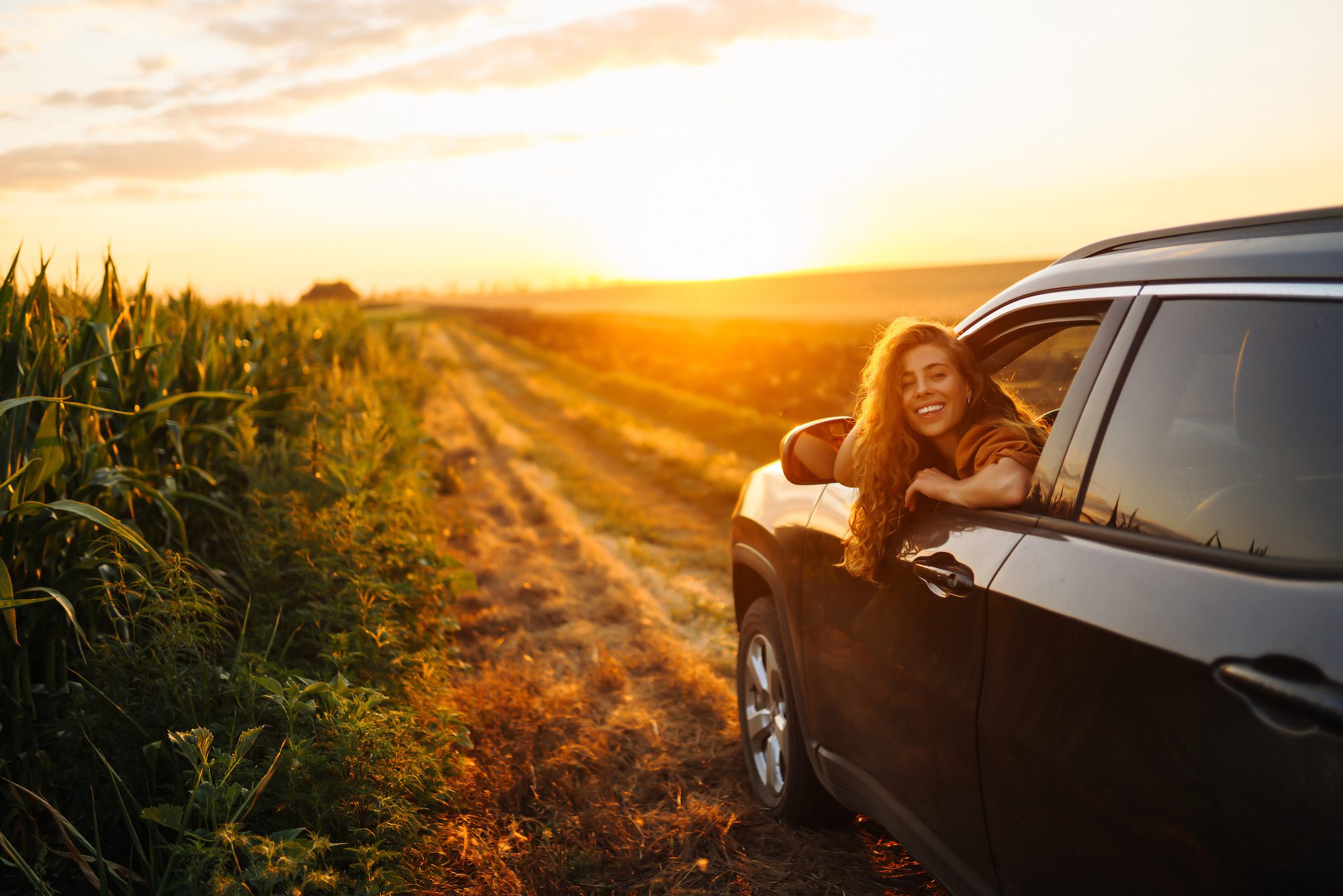 Relaxed happy woman on summer road trip travel in the car. Lifestyle, travel, tourism, nature, active life. ICT Insurance Osage City KS, ICT Insurance Group
